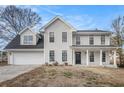 Two-story house with a neutral exterior, a covered porch, and a front yard at 537 N Cedar N Ct, Riverdale, GA 30274