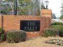 Brick entrance to The Falls community with landscaping and a sign at 115 The Falls Blvd, Covington, GA 30016