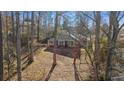 Spacious backyard surrounded by lush trees, offering privacy at 1440 Teaberry Cir, Lawrenceville, GA 30044