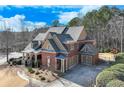 Two-story home with a three-car garage, a large backyard, and a basketball court at 2976 Cambridge Hill Dr, Dacula, GA 30019