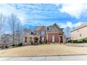 Two-story brick home with stone accents and a large front yard at 2976 Cambridge Hill Dr, Dacula, GA 30019