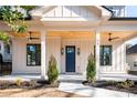 Inviting front porch with wooden ceiling and blue door at 17 Rockyford Ne Rd, Atlanta, GA 30317