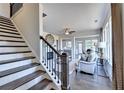 Modern staircase leading to upper level; view of living area at 1934 Asher Ln # 060, Conyers, GA 30013