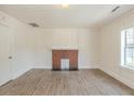 Cozy living room featuring fresh paint, a fireplace, and luxury vinyl plank flooring throughout at 161 Adair Se Ave, Atlanta, GA 30315