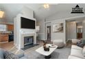 Virtually staged living room with fireplace and kitchen view at 2675 Park Ave, Austell, GA 30106