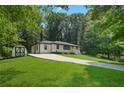 Cute ranch home nestled in a wooded lot, featuring a long driveway at 4291 Lamar St, Decatur, GA 30035