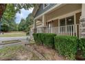 Inviting front porch with stone accents and lush greenery at 101 Chestnut Dr, Canton, GA 30114