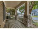 Inviting front porch features wood decking, brick columns, and serene neighborhood views at 101 Chestnut Dr, Canton, GA 30114