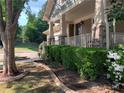 Landscaped front yard with lush greenery and a welcoming porch, enhancing the curb appeal at 101 Chestnut Dr, Canton, GA 30114