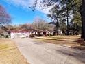 Ranch house with a long driveway and mature trees at 201 E Simon E Ter, Atlanta, GA 30318