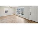 Bright living room featuring new vinyl floors, neutral paint, a ceiling fan and natural light from a window at 1820 Arkose Dr, Atlanta, GA 30316