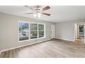 Spacious living room featuring new vinyl floors, neutral paint, and large windows offering views of the front yard at 1820 Arkose Dr, Atlanta, GA 30316