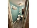 Small bathroom with teal walls and grey flooring at 3882 Parklane Dr, Clarkston, GA 30021