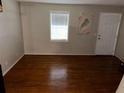 Simple living room with hardwood floors and a white door at 3882 Parklane Dr, Clarkston, GA 30021