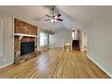 Bright living room with hardwood floors, a stone fireplace, and vaulted ceilings at 4049 Maxanne Nw Dr, Kennesaw, GA 30144