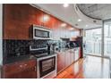 Modern kitchen with dark wood cabinets and granite counters at 400 W Peachtree Nw St # 2810, Atlanta, GA 30308