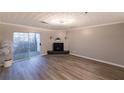 Living room with hardwood floors, fireplace and sliding glass door to balcony at 970 Sidney Marcus Ne Blvd # 2113, Atlanta, GA 30324