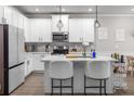 Modern kitchen with white cabinets and kitchen island at 5535 Rockfern Dr, Lilburn, GA 30047