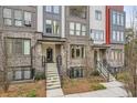 Modern townhome exterior showcasing brick facade, stairway entrance, and clean landscaping at 400 Pratt Se Dr # 1403, Atlanta, GA 30315