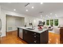 Contemporary kitchen island with stainless steel appliances, hardwood floors, and bright living space at 273 12Th Ne St # 210, Atlanta, GA 30309