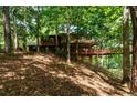 House nestled in a wooded area, elevated position at 4955 H D Atha Rd, Covington, GA 30014