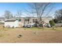 Mobile home's backyard with a shed and spacious yard at 127 Cambridge Ct, Hampton, GA 30228