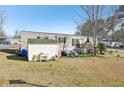 Side view of the mobile home with shed and yard at 127 Cambridge Ct, Hampton, GA 30228