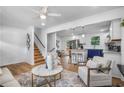 Open concept living room, kitchen and staircase with hardwood floors and modern design at 2522 Candler Woods Dr, Decatur, GA 30032