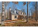 Two-story brick home with a side view showcasing the wooded lot at 5120 Due West Nw Rd, Kennesaw, GA 30152