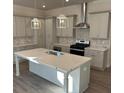 Elegant kitchen featuring gray cabinets, an island with a sink, stainless steel appliances, and designer light fixtures at 1105 Cooks Farm Way, Woodstock, GA 30189