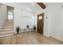 Light and airy entryway with wood floors and bench at 3613 Embry Cir, Chamblee, GA 30341