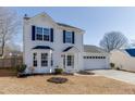 Two-story house with white siding, black shutters, and a white garage at 2463 Candlewood Way, Lawrenceville, GA 30044