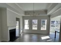 Open living room featuring a fireplace, recessed lighting, and a tray ceiling at 1109 Cooks Farm Way, Woodstock, GA 30189