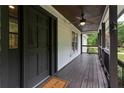 Inviting front porch with dark stained wood floors and ceiling at 2100 Wood Ct, Marietta, GA 30062