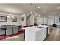 Open concept kitchen with island, white cabinetry, and dining area at 3179 Clairebrooke Ave, Atlanta, GA 30341