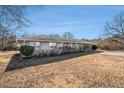 Ranch style home with a large yard at 6747 Rockland Rd, Lithonia, GA 30038