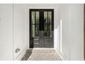 Black double front doors with glass panes and brick walkway at 3910 W Cooper Lake Se Dr, Smyrna, GA 30082