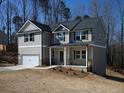Gray home with a covered porch, and a two car garage provides an inviting curb appeal at 250 Shawnee Trl, Dallas, GA 30157