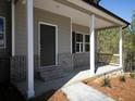 Home's covered front porch includes brick accents, and is a welcoming spot to relax at 250 Shawnee Trl, Dallas, GA 30157