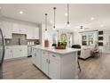 Open concept kitchen with white cabinets, quartz countertops, and an island at 2580 Ravencliff Dr # 159, Austell, GA 30168
