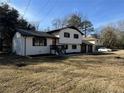Two-story home featuring white painted brick, dark trim, and a well-manicured lawn at 2715 Heritage Ln, Morrow, GA 30260