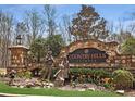 Country Hills Estates entrance with stonework and Gathering sculptures at 465 Belada Blvd, Sandy Springs, GA 30342