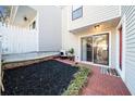 Cozy outdoor patio offers privacy with a brick surface, mulch bed, and sliding glass door at 2678 Greentree Se Dr, Marietta, GA 30067