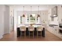 Modern kitchen with white cabinets, center island, and stainless steel appliances at 415 Mayfair Ct, Alpharetta, GA 30009