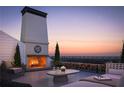 Spacious rooftop terrace with fireplace and city views at 415 Mayfair Ct, Alpharetta, GA 30009
