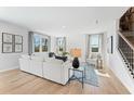 Spacious living room featuring hardwood floors, large windows, and a comfortable sectional sofa at 7049 Brushwood Bend (Lot 59), Lithonia, GA 30058