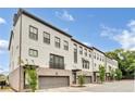 Angle shot of a row of modern townhomes featuring brick and attached garages at 215 Arizona Ne Ave # 2, Atlanta, GA 30307