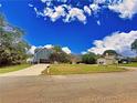 Street view showing a two-story house with gray siding and a detached garage at 305 Rampart St, Mcdonough, GA 30253