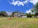 Lovely two story home with a well-manicured lawn and mature trees around the property at 305 Rampart St, Mcdonough, GA 30253
