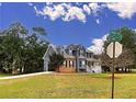 Two-story house with gray siding, brick accents, and a detached garage at 305 Rampart St, Mcdonough, GA 30253